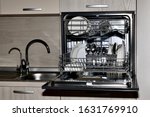 Dishwasher with dishes, built at the sink level with dryer and two taps with tap water and filtered, front view.