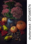 Small photo of still life of tz apples, pears, pumpkins, acorns, rowan berries on a dark background