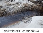 Small photo of a small river flows mightily to the sea after rain