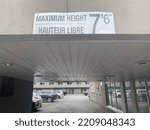 Small photo of Ottawa Ontario Canada September 22 2022. Econo Lodge hotel maximum Height sign seven feet six inches overtop of a car park entrance way.