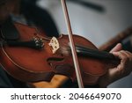 A closeup shot of a violinist playing the violin