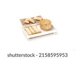 Small photo of A white plate with a truckle of cheese with slices and bread isolated on the white background