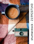 Small photo of FORSYTH, UNITED STATES - Aug 19, 2019: A top view of coffee and a vintage camera on a blanket