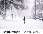 People walking on a city street during heavy snow storm  Climate change, extreme weather  Storm Filomena in Madrid  Arturo Soria area