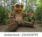 Small photo of BOOTHBAY, US - Aug 20, 2021: A wooden troll sculpture at Coastal Maine Botanical Gardens in Boothbay