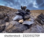 Small photo of Carin Stones at the sea Steinmaennchen Teneriffa Meer Poris de Abona spirituell Yoga canarian islands on a cloudy day at the seeside mediation
