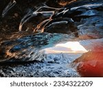 Small photo of The ice cave of the Katla volcano with the sunset in the background in Iceland