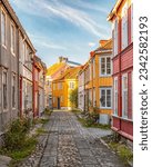 A vertical shot of colorful buildings on an old street in Trondheim, Norway