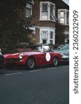 Small photo of PARIS, FR - Aug 31, 2022: A vertical shot of a vintage red MG Midget parked on the streets of London, the UK