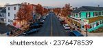Small photo of HAVRE DE GRACE, US - Nov 27, 2020: An empty street in Havre De Grace city illuminated by the golden light of dusk, with parked cars lining the sides of the road
