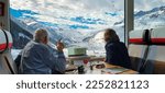 Man points at swiss alps from...