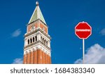 Small photo of A stop sign subtitle coronavirus covid-19 that causes the pandemic represents foregone tourists in Venice Italy