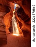 Small photo of Famous midday sun ray in a slot canyon Antelope. The Navajo reservation, Arizona, USA - Travel concept.