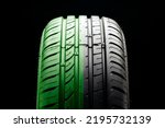 Small photo of tire tread close-up, half green. the concept of an eco-friendly economical tire, fuel economy and safety