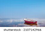 Red Rowing Boat In Calm Waters