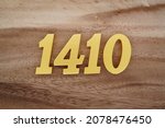 Golden Arabic numerals 1410 on a dark brown to white wood grain background.