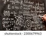 Small photo of Quantum physics operations written by hand with a chalk on the blackboard