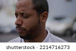 Small photo of One anxious young African American man in distress closeup face. Portrait of a black person with worried preoccupied emotion