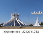 Small photo of Brazilia, Brazil - 10 14 2022: The Cathedral of Brasilia, a crown-like structure, with chandelier-shaped clocks, designed by the Brazilian architect Oscar Niemeyer