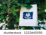 Louisiana state flag printed on a Christmas shopping bag. Close up of a shopping bag as a decoration on a Xmas tree on a street. Christmas shopping, local market sale and deals concept. 
