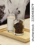 Small photo of Unmixed iced coffee—warm milk and coffee ice cubes