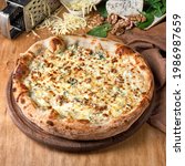 Small photo of Four Cheese Pizza or Quattro Formaggi Pizza topped with mozzarella, gorgonzola on wooden background. Fast food lunch for picnic company, photo for the menu. Italian cuisine.