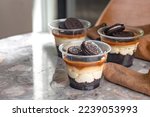 Mini desserts snacks in plastic cups. On the table Cheescake to go
