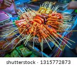 Small photo of Thai Street Food Grilled meat on the crat. Side walk in Chiang Mai Thailand