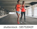 Two female runners jogging...