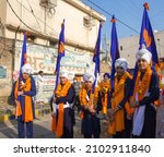 Small photo of Ambala, India- December 08 2021: 'Panj-Pyaare' (Five Khalsa children) dressed up in traditional attire holding flags during Sikh procession in the streets of a town in Haryana,India.