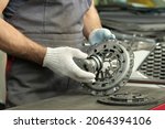 Small photo of Spare parts for cars. Car clutch kit. The car mechanic monitors the technical condition of the drive disc, the driven disc and the exhaust bearing.
