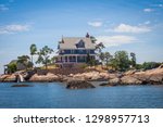 Thimble Island homes shown to the public at a popular public beach tour from a boat ride tour over water.