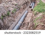 Small photo of Laying new water pipes in a concrete ditch. Thermal line. Up close