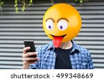 Emoji head man using a smartphone. Emoji concept