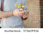 Close-up of man using smartphone sending emojis. Social concept.