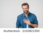 Small photo of Happy young caucasian man in denim clothes laughing, touched with a compliment, good sense of humor isolated in white background