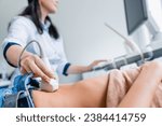 Small photo of Close up of female doctor doing ultrasound probe on patient stomach in medical clinic. Gastritis prevention. Pregnancy, maternity concept. Ovulation period