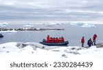 Small photo of Portal Point, Antarctica - March 5, 2022: Expedition cruise ship passengers in an inflatable boat landing on the seventh continent