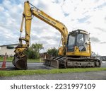 Small photo of Komatsu PC138US excavator, tight tail swing radius short digger at roadworks site. Auckland, New Zealand - November 26, 2022