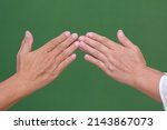 Small photo of Male and female hands greeting one another on Ramadan Mubarak Holiday H 1443