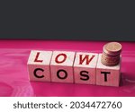 Low cost words on Wooden blocks and coins stack. Sale discount reselling business concept.