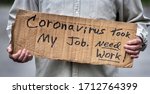Small photo of Closeup man holding handwritten cardboard sign, Coronavirus Took My Job, man's hands, unemployed, downsized, job, employment, job loss, fired, discharged worker, pandemic, job market, economy, work