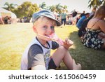 Boy eating fairy floss / cotton candy at local market in Mackay, Queensland Australia