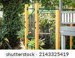 Small photo of Backyard cubby house with monkey bars