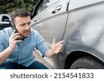 One man reporting car damage calling insurance service