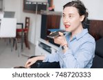 Woman talking on the phone with the digital voice assistant