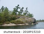 Small photo of granite rocks and windswept pines in Wani Bay off Twelve Mile Bay in Georgian Bay Ontario canada