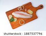 fresh fillet dory fish on wooden tray