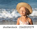 Small photo of Sea Children Holiday. Sea Kids Portrait on Sea Background. Happy Child Tanning Sunbathing with Sunscreen on Face on Sea Coast. Children Sunscreen Care.