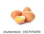 Chicken eggs and half broken egg with yolk  isolated on white background